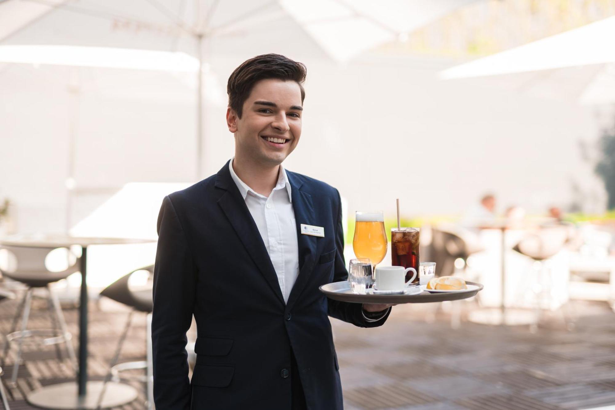 Doubletree By Hilton Wroclaw Hotel Exterior photo A waiter