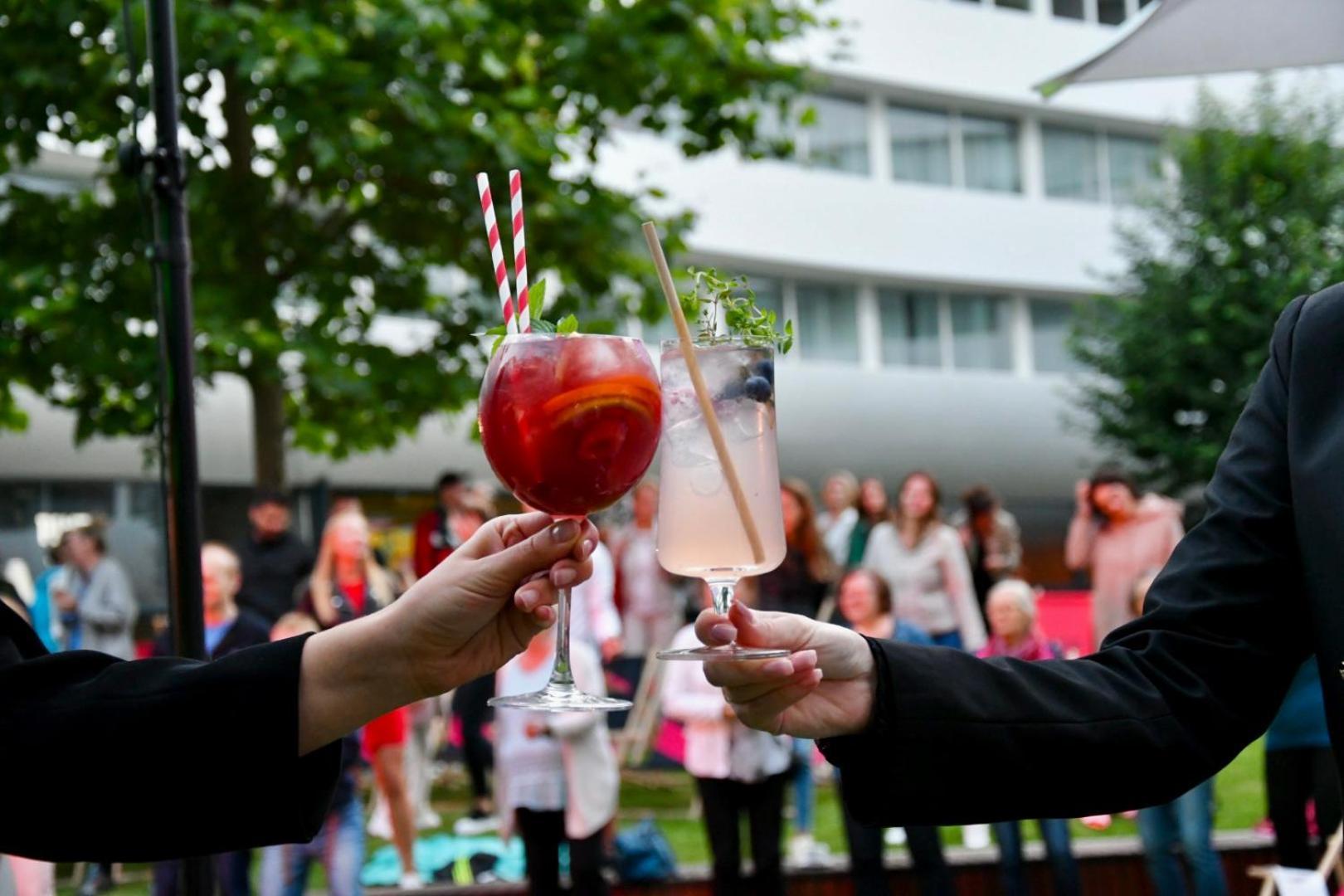 Doubletree By Hilton Wroclaw Hotel Exterior photo Two people toasting with cocktails